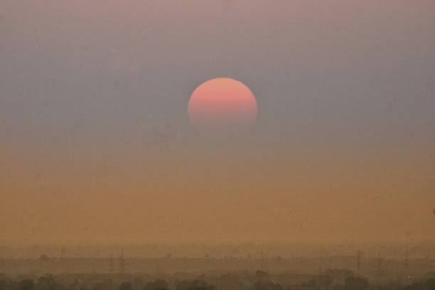 istock Beautiful sunset over the city haze image 1427782554