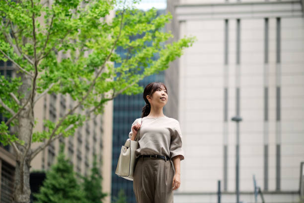 istock Confident businesswoman and office building 1427797441
