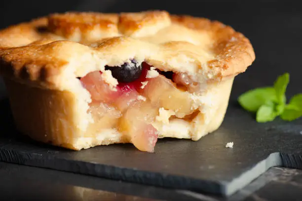 Freshly made and baked apple and blueberry pie with pastry leaves