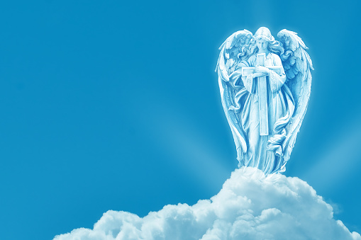 Angel on white cloud against blue clear sky with copy space