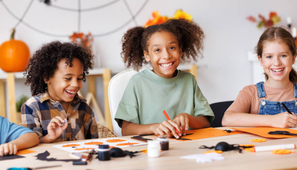 istock Happy multinational group of children making Halloween home decorations together 1427828070
