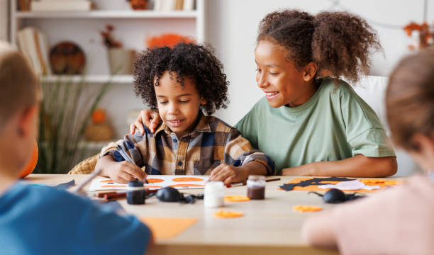 istock Happy multinational group of children making Halloween home decorations together 1427828098