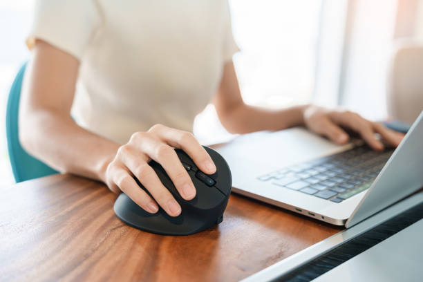 istock woman hand using computer ergonomic mouse, prevention wrist pain because working long time. De Quervain s tenosynovitis, Intersection Symptom, Carpal Tunnel Syndrome or Office syndrome concept 1427828193