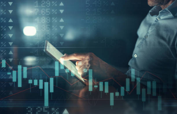 istock IT businessman with tablet and trading infographic chart or big data analytics for finance software and screen overlay. Information technology digital expert or trader in corporate fintech statistics 1427840762
