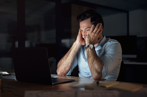Stress, depression and overworked man working late night and struggling with error, 404 or internet crash on laptop. Male entrepreneur suffering from burnout, mental health and frustrated at office