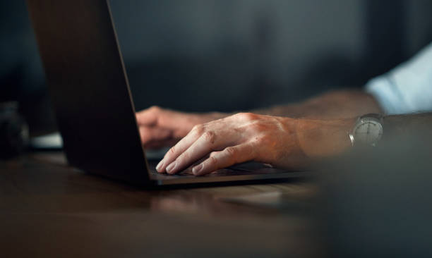 istock Cyber security man, hands and laptop for digital cybersecurity, web design or ux seo software in night office. Zoom on computer engineer, programmer or developer working on database technology coding 1427840834