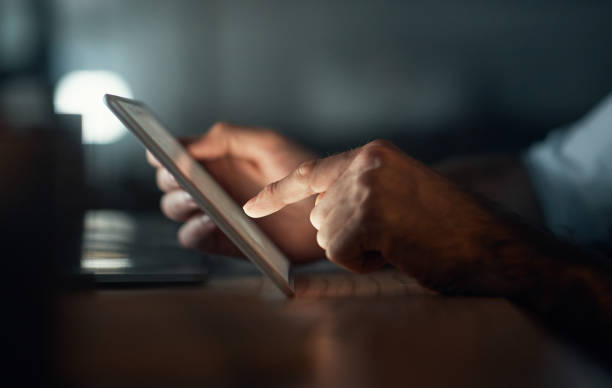 istock Business, hands and typing on tablet at night for a work report deadline in dark office. Corporate career employee working on project commitment with digital keyboard screen technology. 1427840857