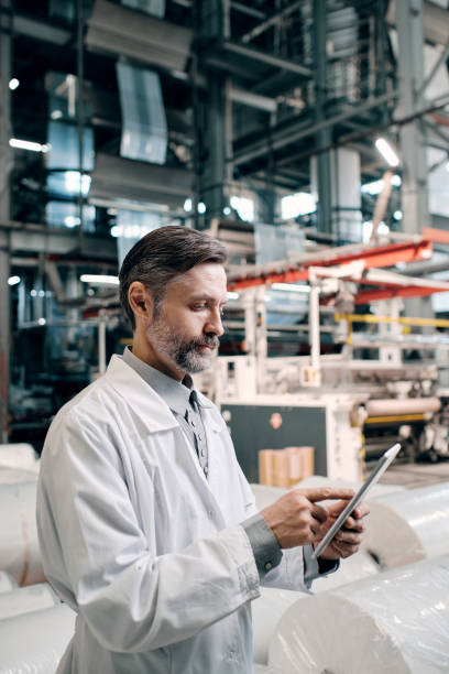 istock Man at factory with tablet 1427844627