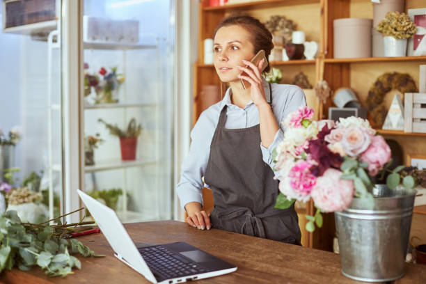 istock Female florist taking delivery order online 1427845746