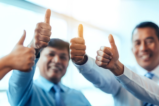 Multiracial group of business persons students with thumbs up learning success hand gesture positive emotion success satisfaction together in bright business office