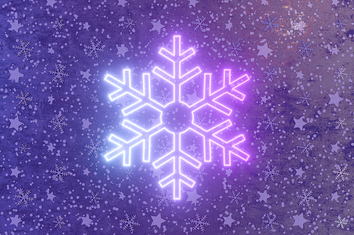 Christmas ornament snowflake neon lighting sign on black snowy wall, 3d render.