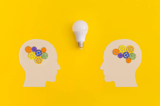 istock Human heads with gears on yellow background 1427848463