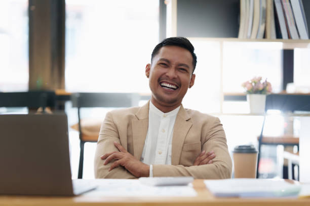 istock Asian Businessman smiling and working to analyze technical price graph and indicator. finance concept 1427852056