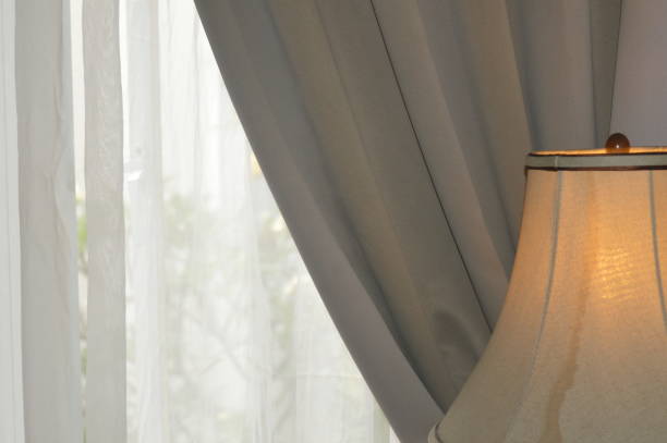 istock a lamp stand against a gray window curtain interior in a hotel 1427852579