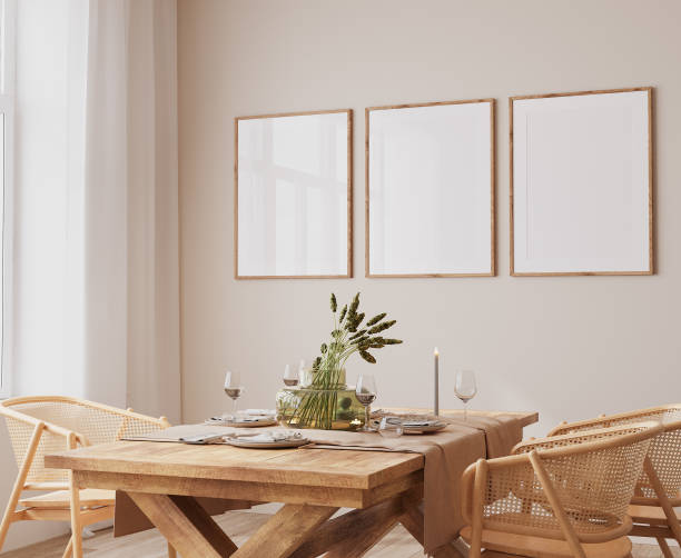 Frame mockup in Scandinavian dining room design, rattan chairs and wooden dining table on bright beige interior background stock photo