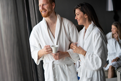 Beautiful happy young couple enjoying wellness spa resort treatments