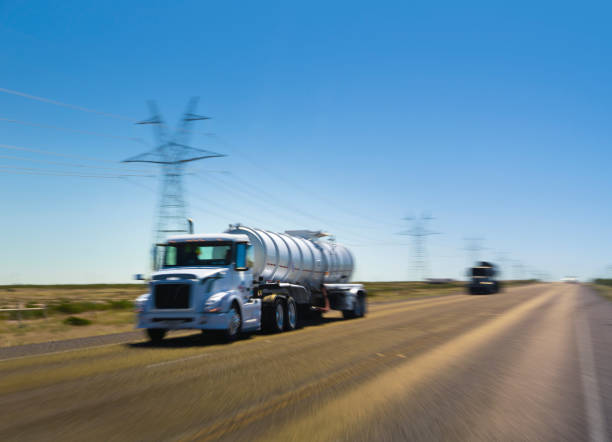 semi truck transporting chemicals propane driving on the highway - oil industry industry new mexico oil drill imagens e fotografias de stock