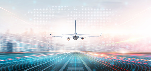 Technology digital future of commercial air transport concept, Airplane taking off from airport runway on city skyline and world map background with copy space, Moving by speed motion blur effect