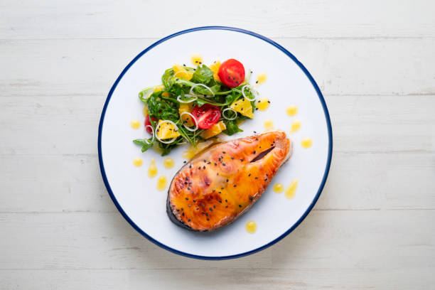 istock Grilled salmon with orange sauce and a salad. Typical Mediterranean coast dish. 1427863948