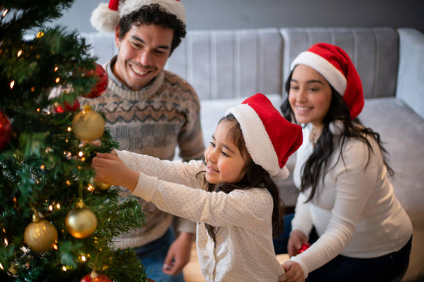 Happy family decorating the Christmas tree