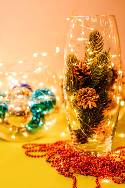 istock Cones in a glass vase and garlands on the table 1427872135
