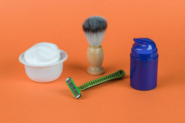 men's shaving kit on a bright orange background. minimal concept of men's hygiene. - shampoo merchandise packaging razor imagens e fotografias de stock