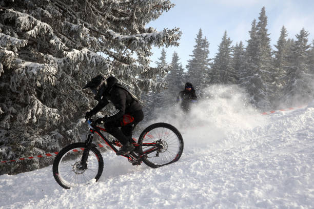 Snowmobile jumping as he tops the mountion.