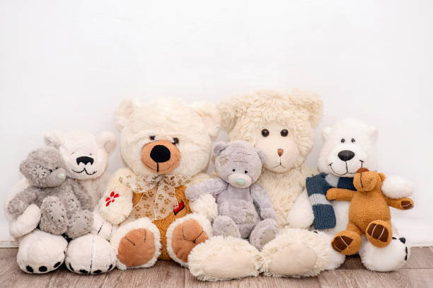 istock Many soft different bears are sitting on the background of a white wall 1427881900