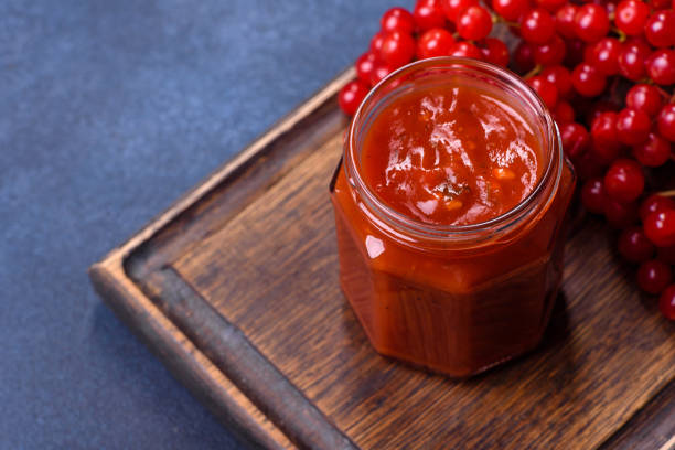 istock Viburnum fruit jam in a glass jar on a dark concrete background 1427882029