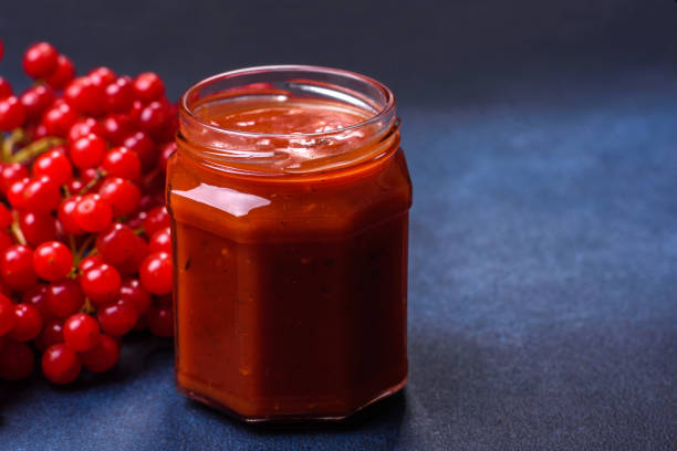 istock Viburnum fruit jam in a glass jar on a dark concrete background 1427882053