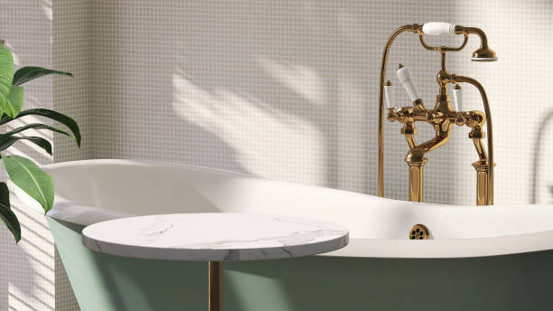 istock Marble top side table by green cast iron bathtub in luxury design bathroom and tropical tree with sunlight from window and leaf shadow on white mosaic wall 1427889569
