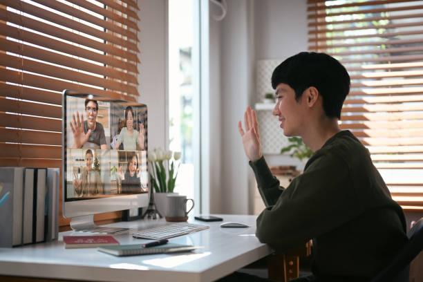 istock Smiling asian man making video call with colleagues during working from home. People and communication concept. 1427894716