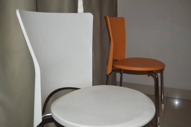 istock orange and white chair background with gray curtains 1427894872