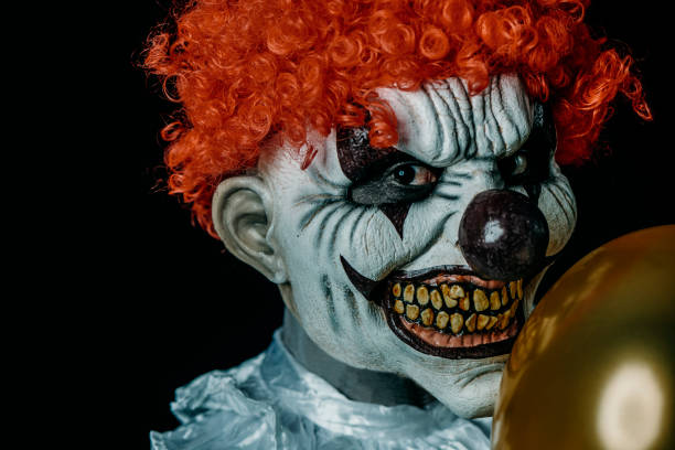 istock creepy evil clown with a golden balloon 1427895103