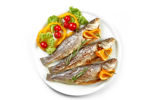 istock Fresh marinated in spices trout fish in a white plate. White background, selective focus 1427898968