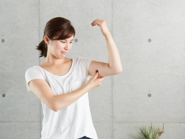 A Japanese woman who worries about sagging upper arms stock photo