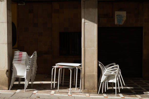 istock Plastic chairs stacked up in front of a closed bar 1427913043