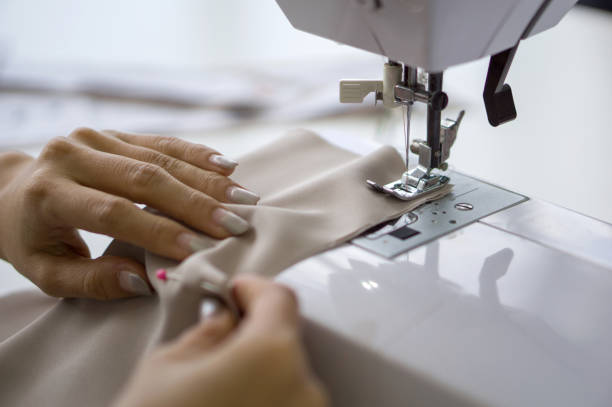 istock The dressmaker elaborately made a  thread pattern on a fine beige fabric. Close up 1427913515