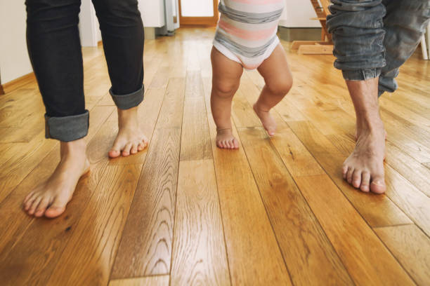 istock Parents teaching their child to walk 1427914213