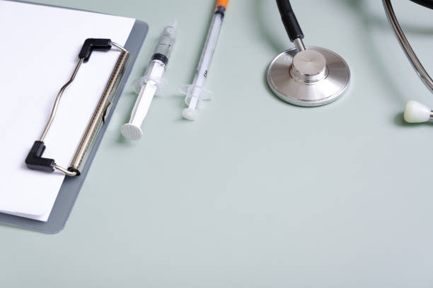 istock Stethoscope, tablet, pills and syringes on colored background with copy space. Abstract medical background 1427916204
