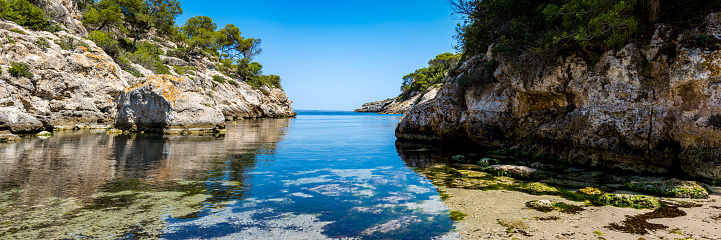 Secret tip untapped natural bathing cove in the southwest of Mallorca in the area of Calvia called Cala Figuera with calm clear water and view to the bay of Palma de Mallorca, without tourists.