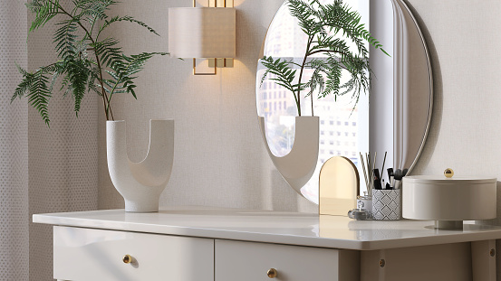 Beautiful and luxury wooden beige dressing table with a vase of tropical plant and frameless round mirror in bedroom with sunlight from window on wallpaper wall for product display