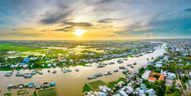 Floating village along Hau river over Vietnam border area, aerial view. The river basin contains a lot of seafood and alluvium for agriculture and economic development in the Mekong Delta