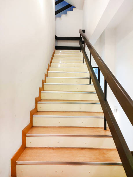 istock Empty wooden staircase of white building 1427920106