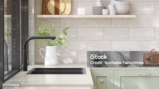 istock Minimal and cozy green kitchen counter with white laminated plastic top and black quartz sink with sunlight from window on wall 1427920226
