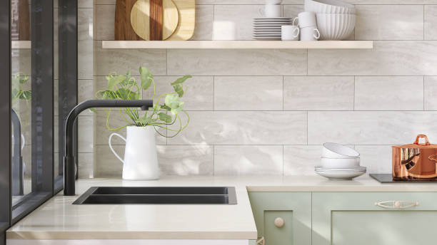 minimal and cozy green kitchen counter with white laminated plastic top and black quartz sink with sunlight from window on wall - dispersa imagens e fotografias de stock