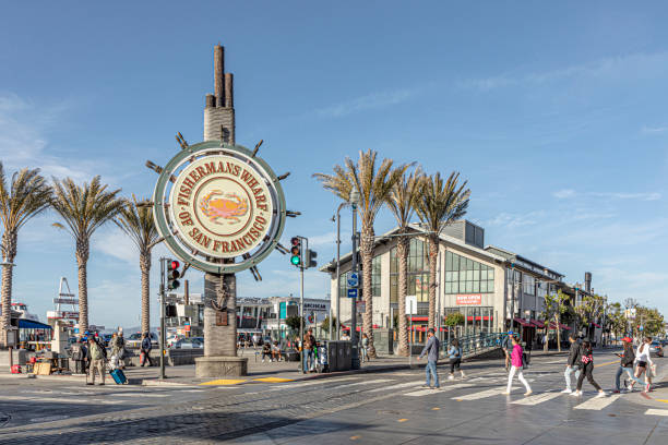 people enjoy Fisherman's Wharf in San Francisco, in dawn. Famous illuminated signage shows fishermens wharf San Francisco, USA - June 7, 2022:   people enjoy Fisherman's Wharf in San Francisco, in dawn. Famous illuminated signage shows fishermens wharf. fishermans wharf stock pictures, royalty-free photos & images