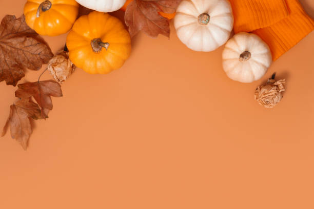 istock Autumn flat lay composition with pumpkins and fallen leaves and sweater with space for text 1427921882