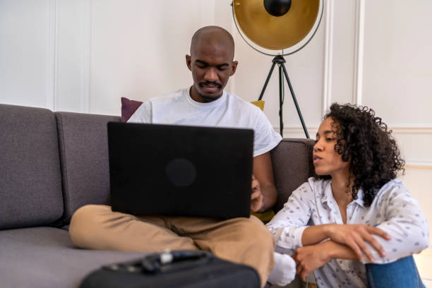 istock Afro couple looking at a laptop at home 1427923933
