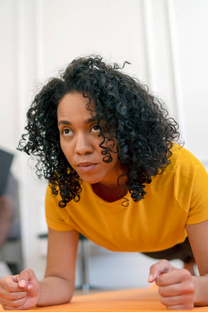 istock African-American woman doing exercises at home. 1427923949